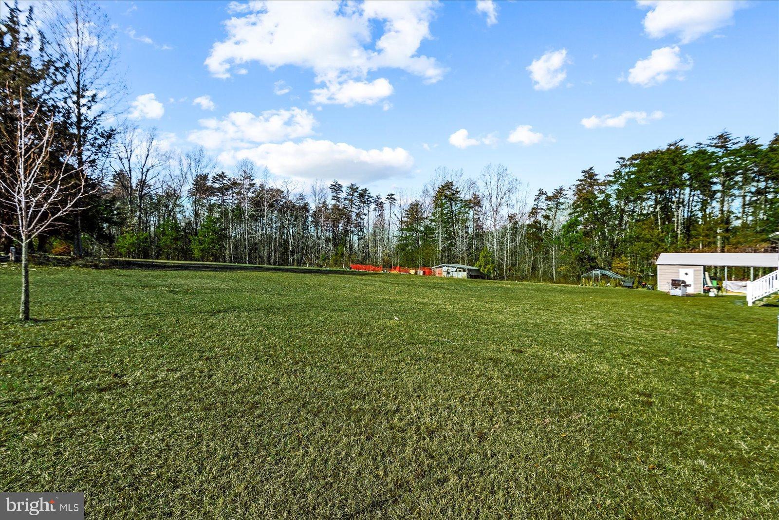 6600 Stubbs Bridge Road Spotsylvania, VA 22551 - Photo 35 of 37 Spacious green expanse under a bright sky.