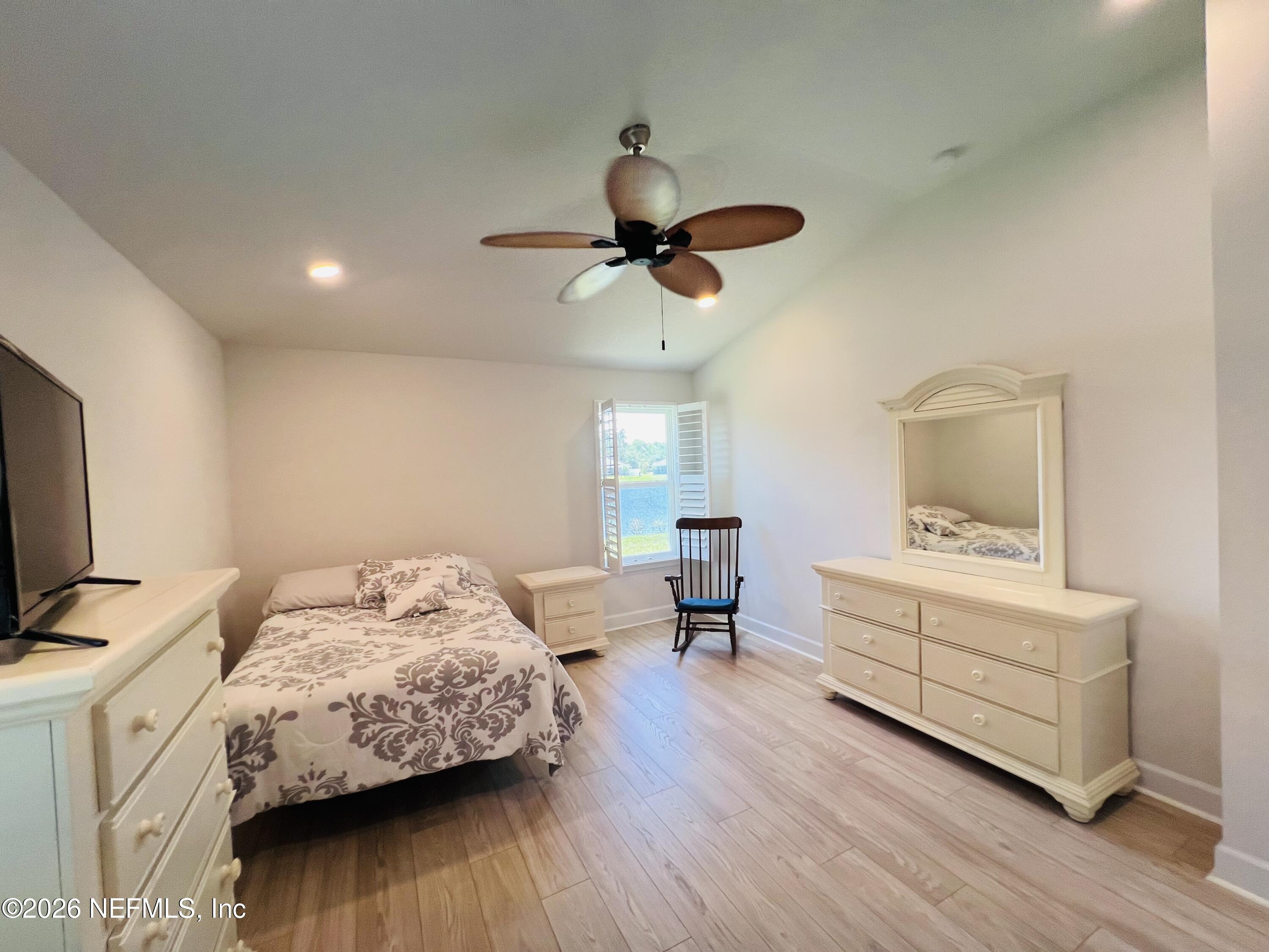 2 Rivertown Road Palm Coast, FL 32137 - Photo 70 of 80 a bedroom with a bed and a chandelier