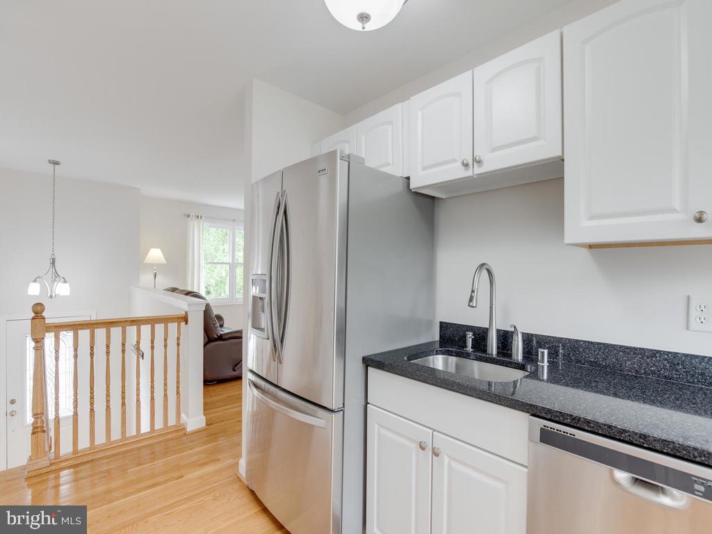 976 Pebblestone Road Pasadena, MD 21122 - Photo 14 of 39 Stainless dishwasher and fridge with ice dispenser