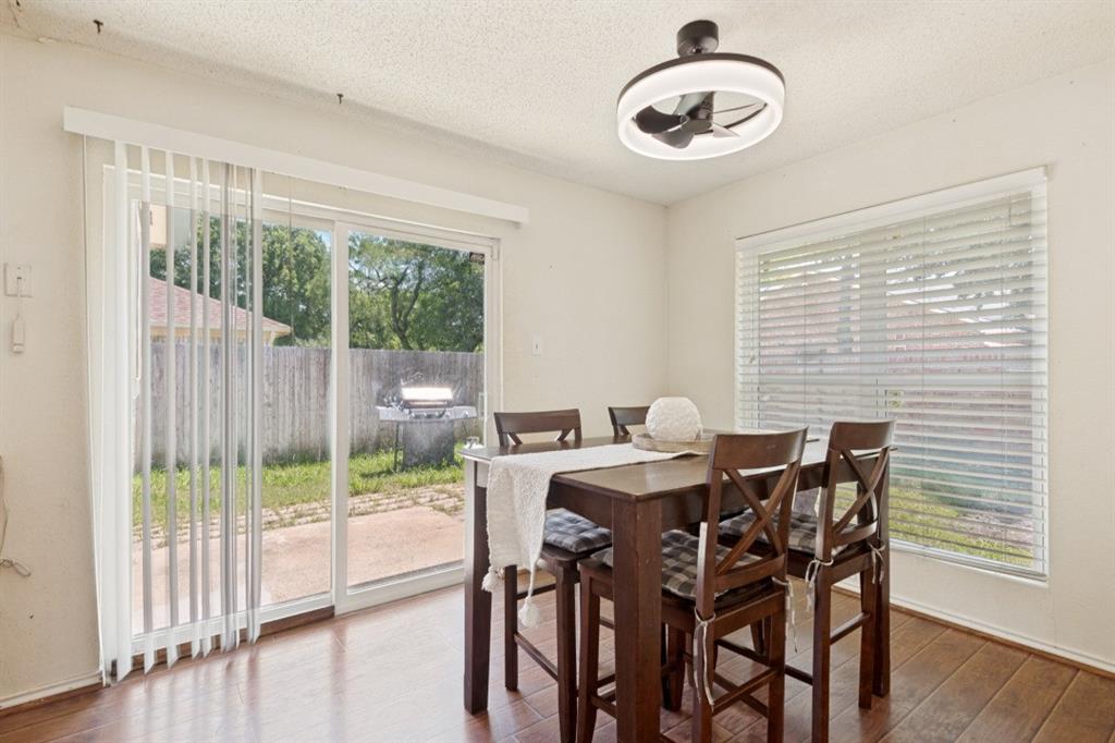 7410 Jessica Way Rowlett, TX 75088 - Photo 13 of 25 a view of a dining room with furniture wooden floor and windows