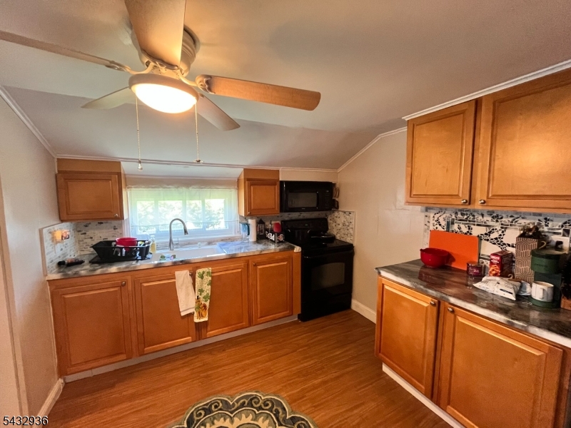 9 New Row Road, Unit A Hibernia, NJ 07842 - Photo 8 of 18 a kitchen with stainless steel appliances granite countertop a sink cabinets and wooden floor