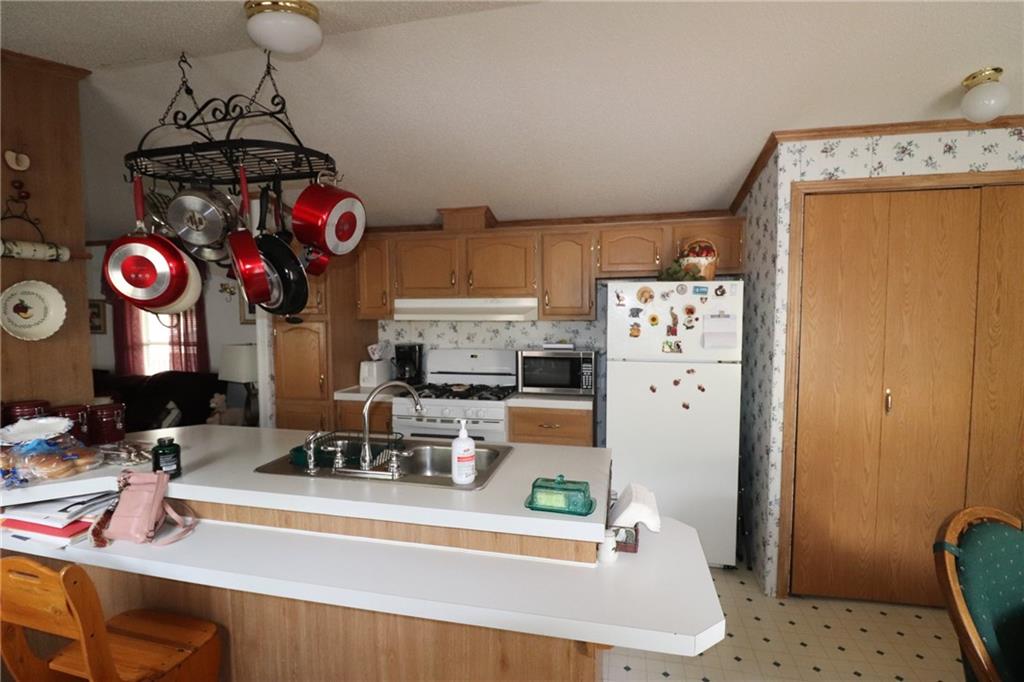 196 Tanner Street Export, PA 15632 - Photo 21 of 23 a kitchen with stainless steel appliances granite countertop a sink dishwasher and a refrigerator with wooden floor