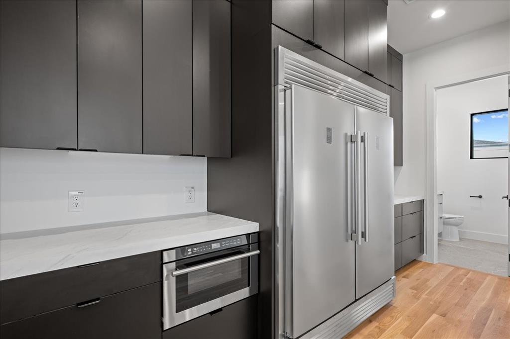4519 Weldon Street Dallas, TX 75204 - Photo 12 of 40 a kitchen with stainless steel appliances a refrigerator and cabinets