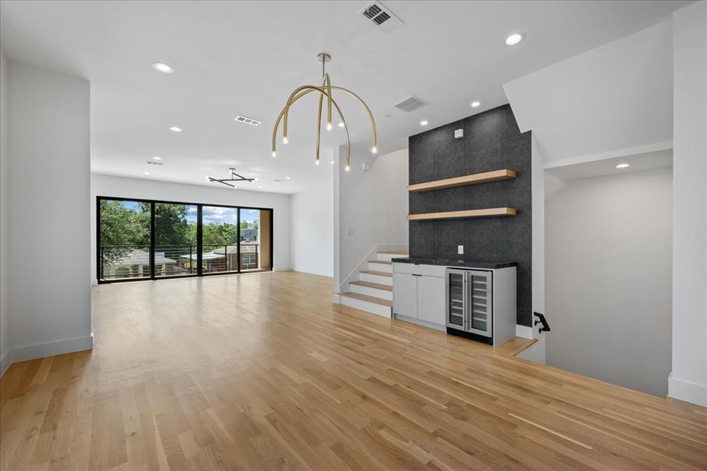 4519 Weldon Street Dallas, TX 75204 - Photo 16 of 40 an empty room with wooden floor and windows