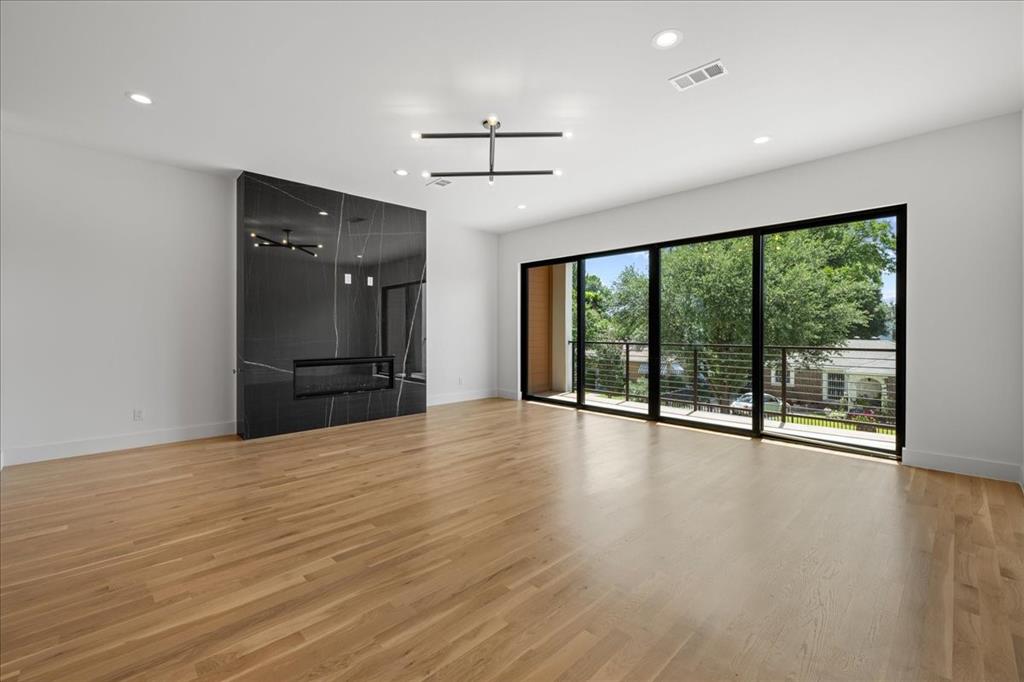 4519 Weldon Street Dallas, TX 75204 - Photo 18 of 40 a view of an empty room with wooden floor and a window