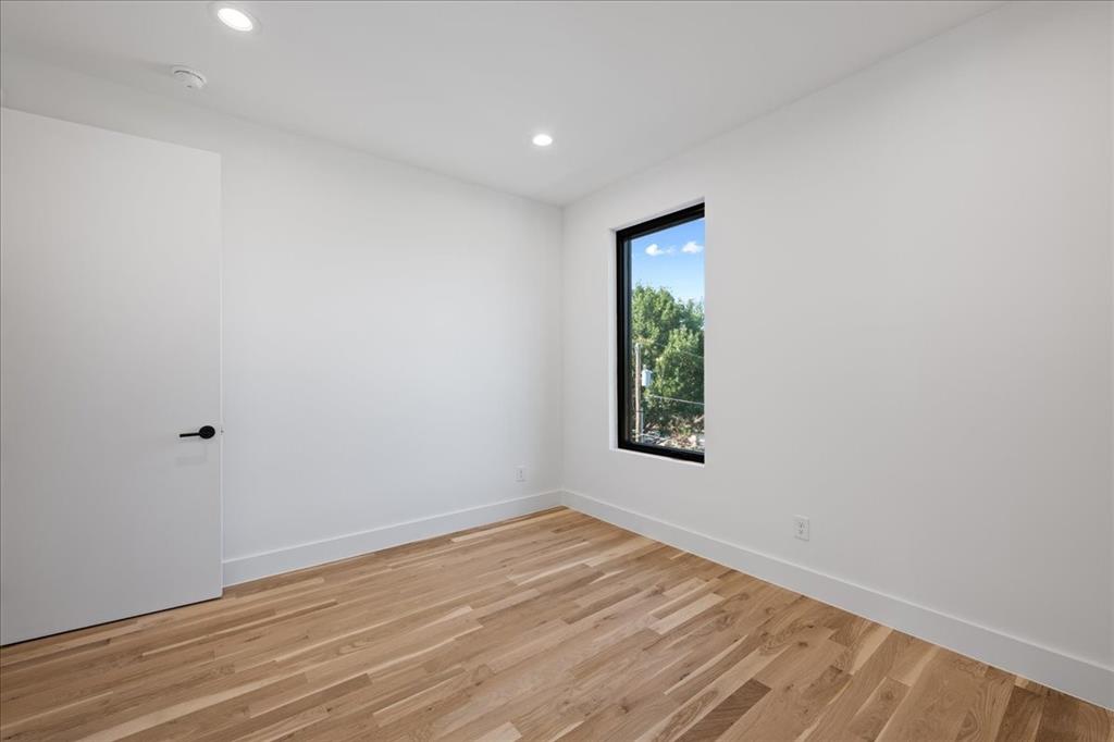 4519 Weldon Street Dallas, TX 75204 - Photo 22 of 40 an empty room with wooden floor and windows