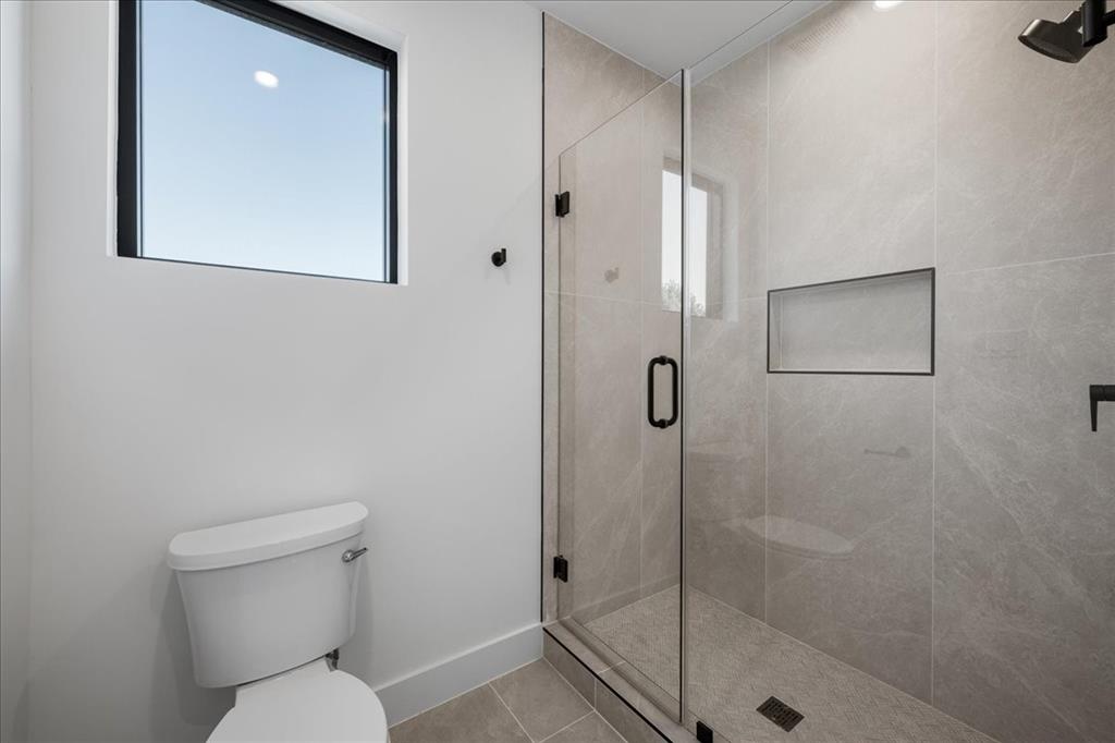 4519 Weldon Street Dallas, TX 75204 - Photo 24 of 40 a bathroom with a toilet and a shower