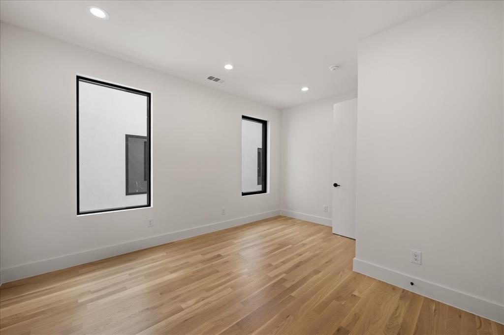 4519 Weldon Street Dallas, TX 75204 - Photo 26 of 40 an empty room with wooden floor and windows