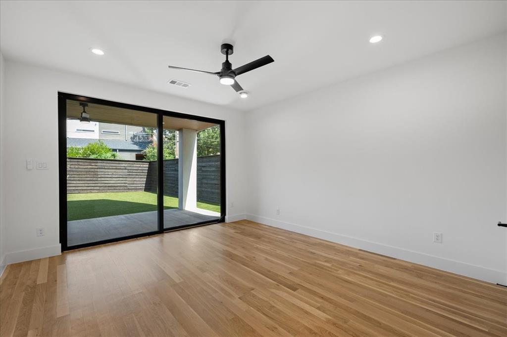 4519 Weldon Street Dallas, TX 75204 - Photo 3 of 40 an empty room with wooden floor and windows