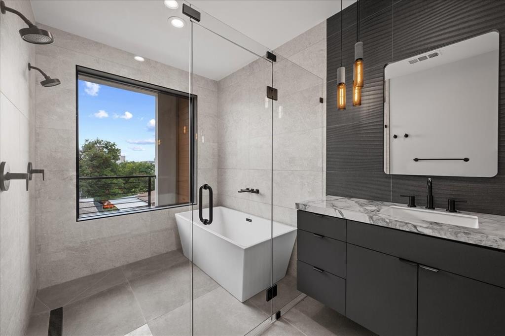 4519 Weldon Street Dallas, TX 75204 - Photo 32 of 40 a bathroom with a tub sink and mirror