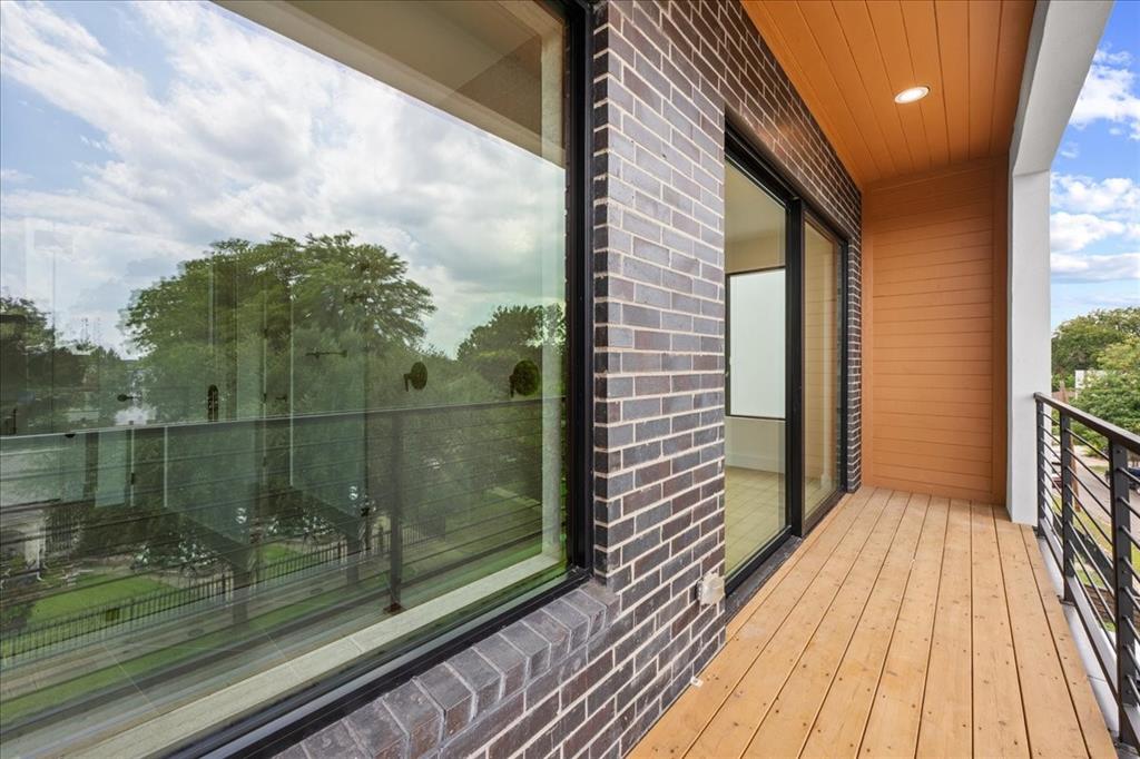 4519 Weldon Street Dallas, TX 75204 - Photo 33 of 40 a view of a balcony with wooden floor and fence