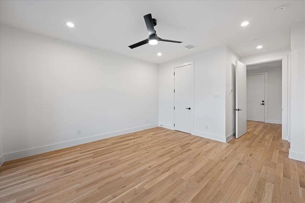 4519 Weldon Street Dallas, TX 75204 - Photo 4 of 40 a view of an empty room with wooden floor and a ceiling fan