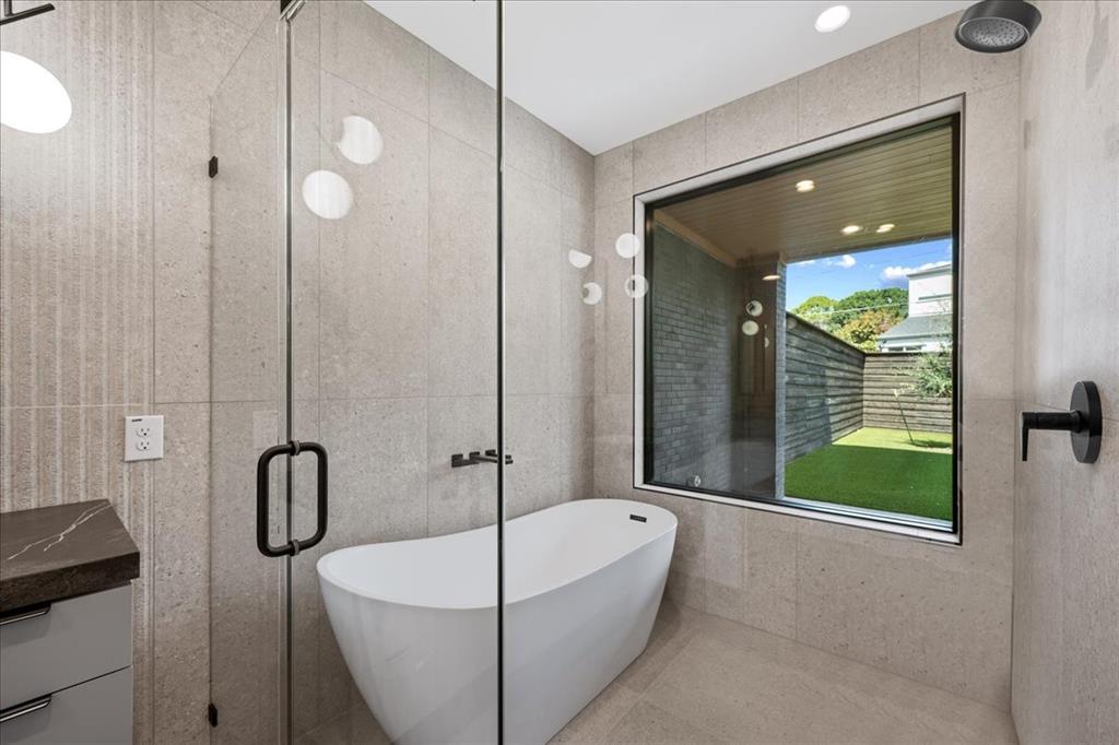 4519 Weldon Street Dallas, TX 75204 - Photo 6 of 40 a bathroom with a tub sink and mirror