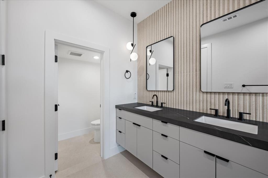 4519 Weldon Street Dallas, TX 75204 - Photo 7 of 40 a bathroom with a granite countertop sink and a mirror
