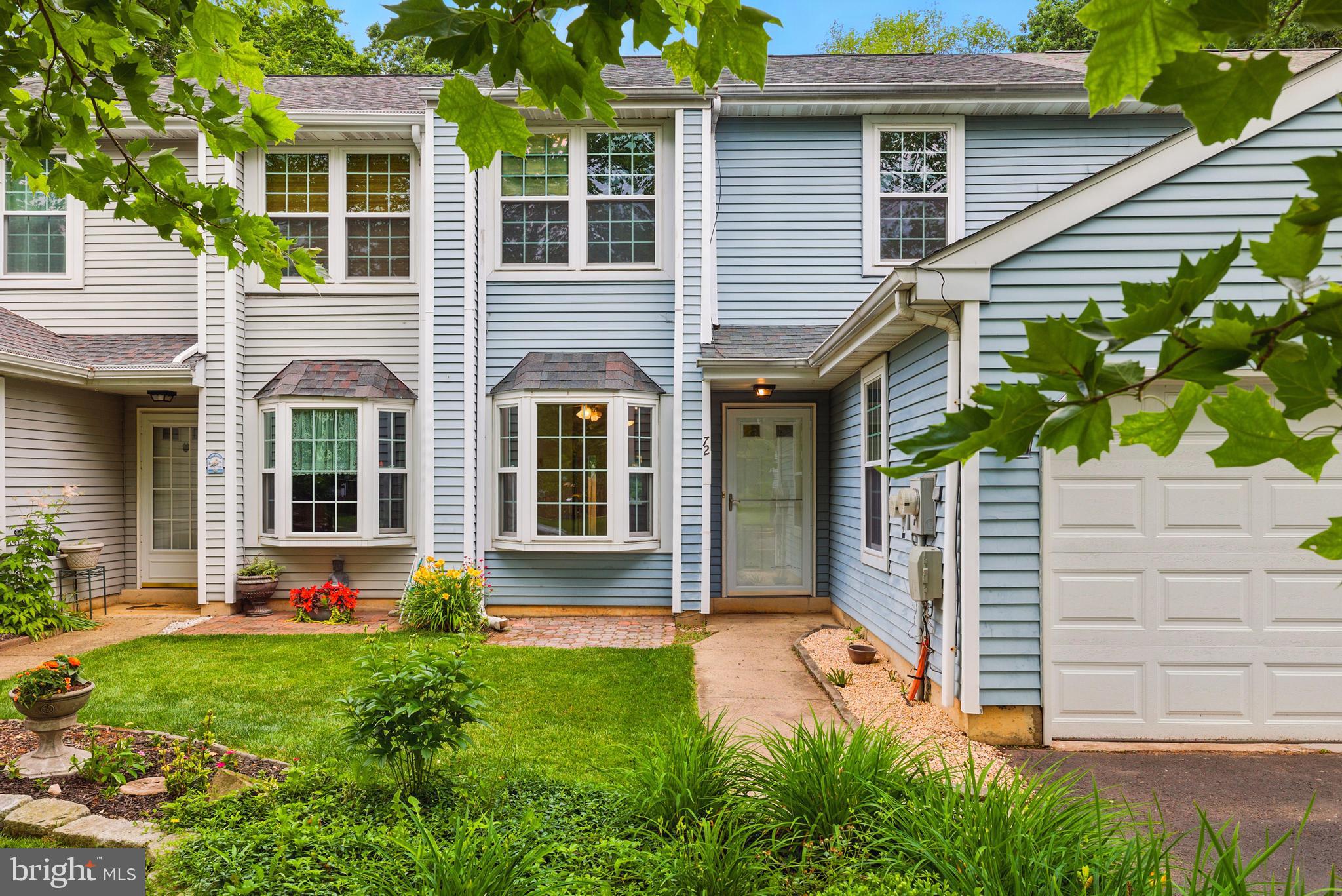 72 Carousel Circle Doylestown, PA 18901 - Photo 1 of 22 a view of a house with brick walls and a yard with plants