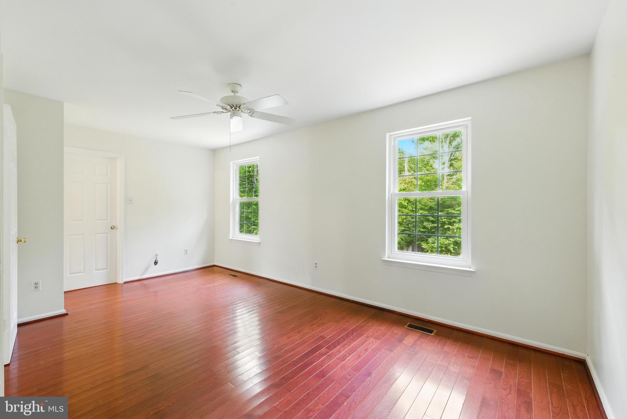 72 Carousel Circle Doylestown, PA 18901 - Photo 14 of 22 an empty room with wooden floor chandelier fan and windows