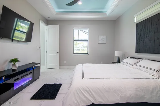 a bedroom with a bed window and television