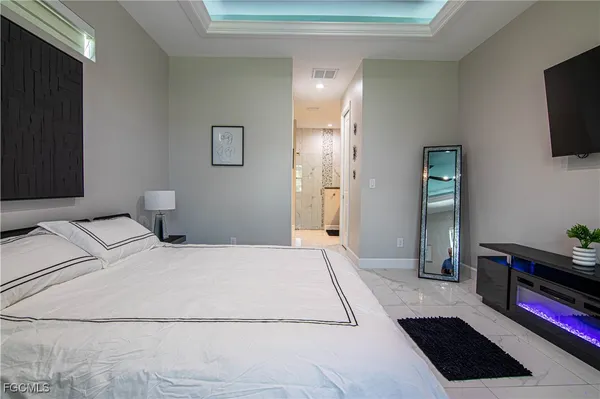 a bedroom with a bed and flat screen tv