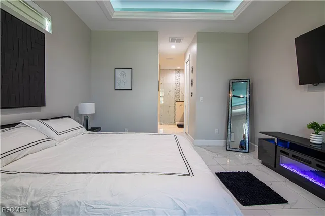 a bedroom with a bed and flat screen tv