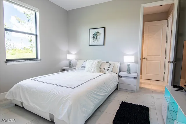 a bedroom with bed and a window