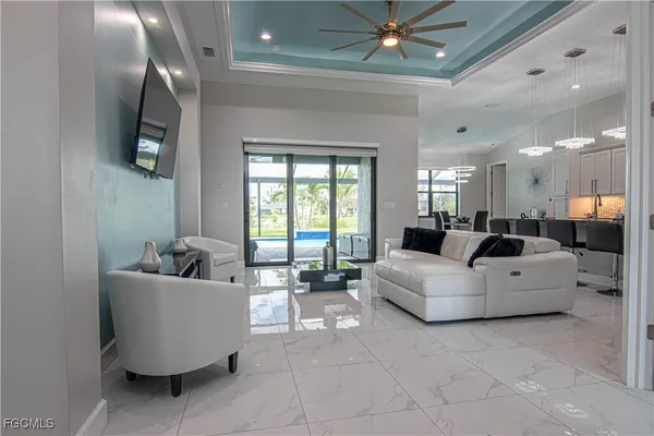 a living room with furniture and a chandelier