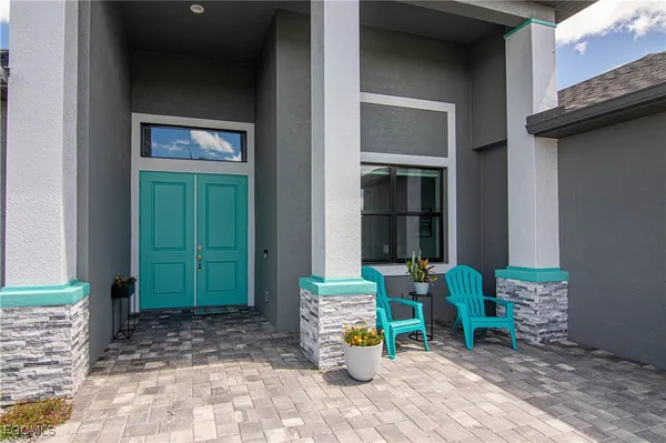a front view of a house with outdoor seating