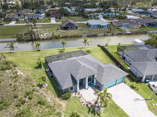 an aerial view of a house with a lake view