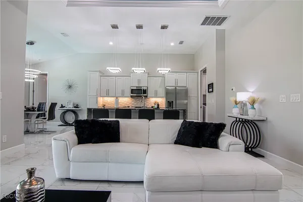 a living room with furniture and a large mirror