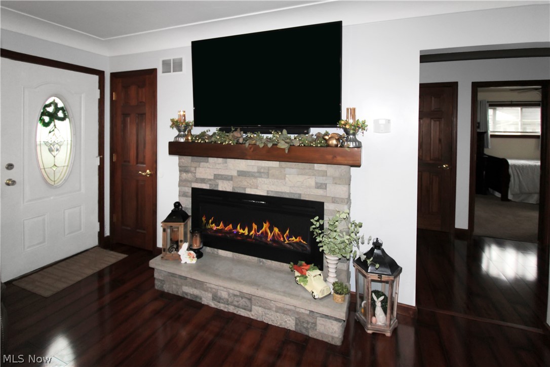 38 Meachem Road Port Clinton, OH 43452 - Photo 12 of 35 Living room featuring dark hardwood / wood-style flooring and a stone fireplace