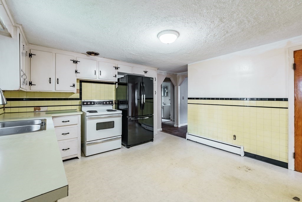 96 Strong Street Springfield, MA 01104 - Photo 7 of 33 a kitchen with granite countertop cabinets and white appliances