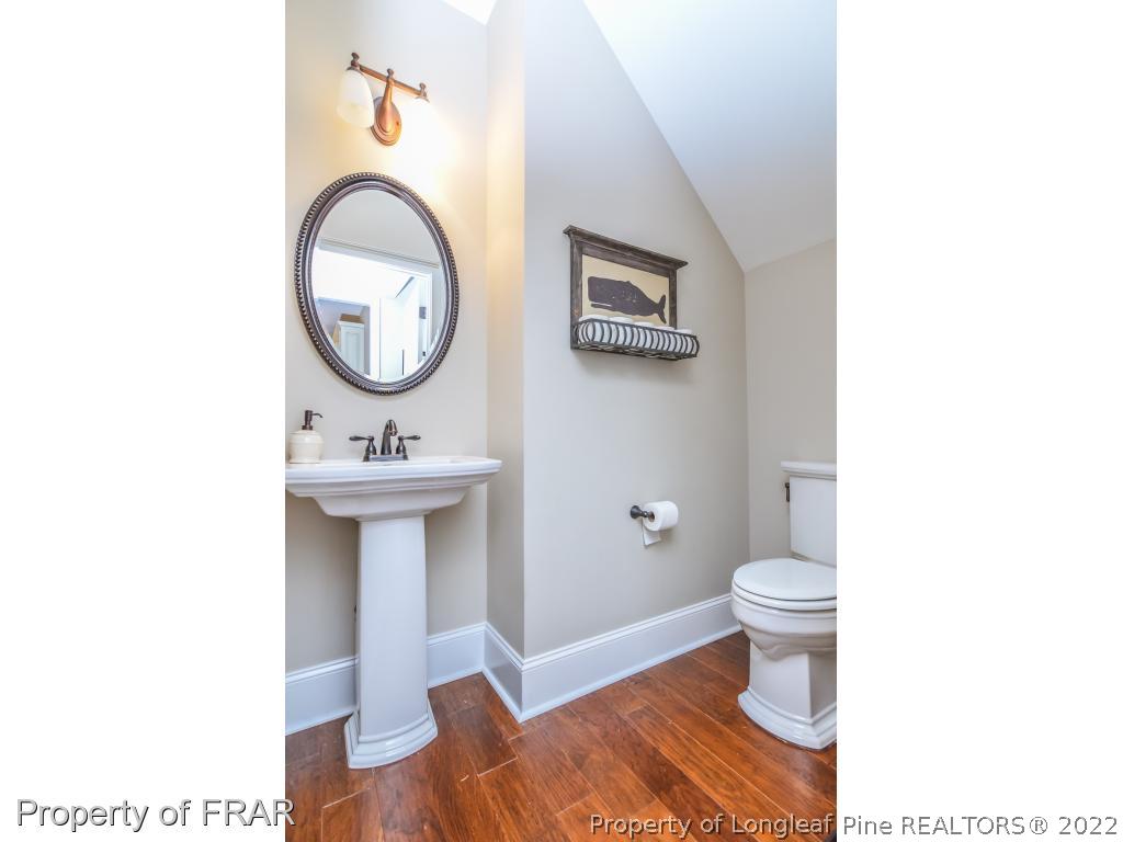 5491 Murphy Road Stedman, NC 28391 - Photo 12 of 33 a bathroom with a sink a toilet and a mirror