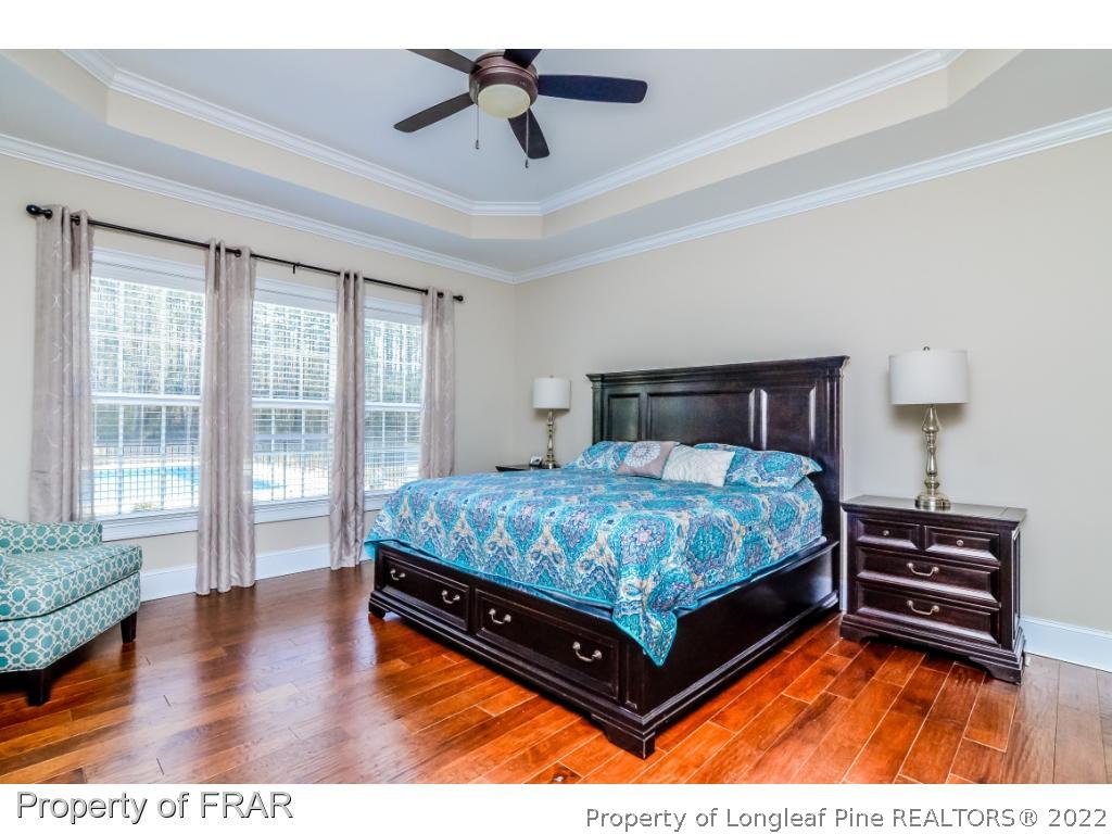 5491 Murphy Road Stedman, NC 28391 - Photo 13 of 33 a bedroom with a bed and wooden floor