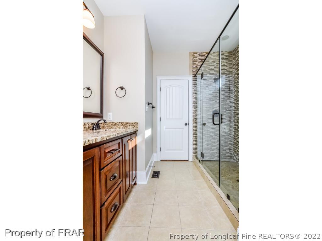 5491 Murphy Road Stedman, NC 28391 - Photo 15 of 33 a hallway with cabinets and a stove
