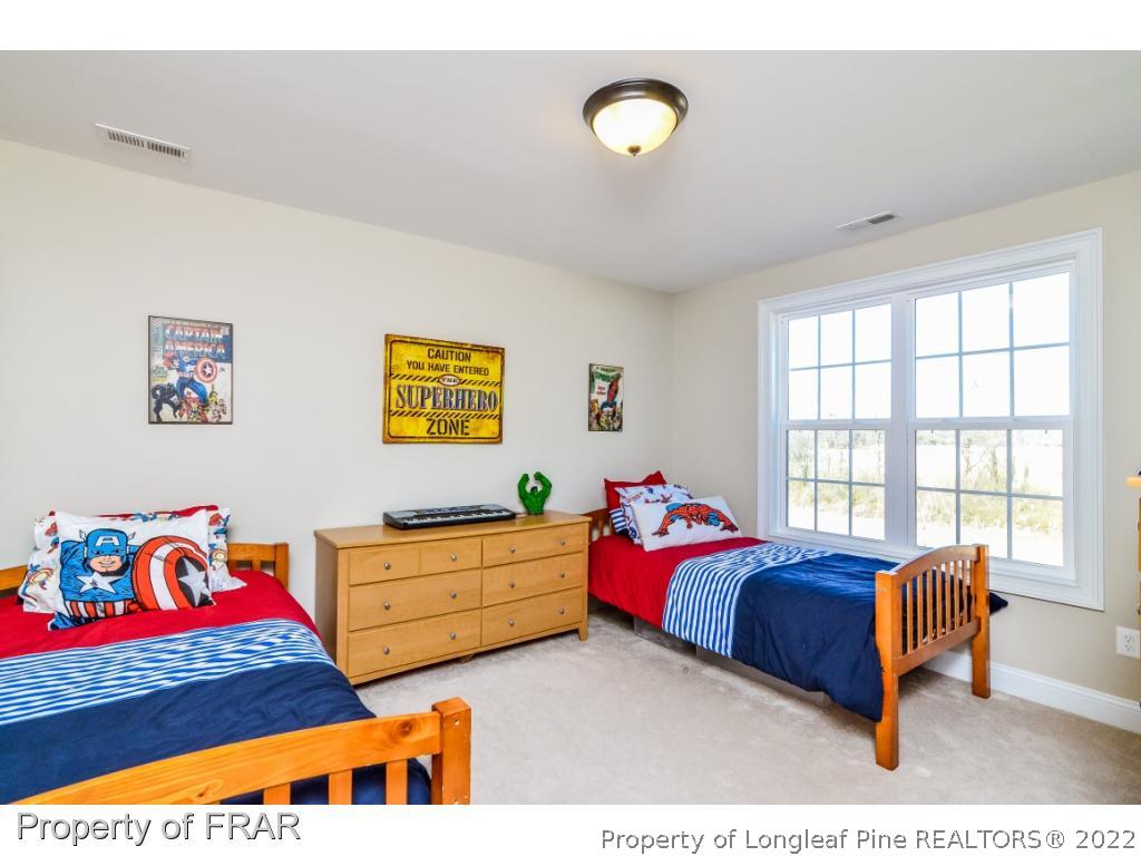 5491 Murphy Road Stedman, NC 28391 - Photo 23 of 33 a bedroom with two beds and a couch