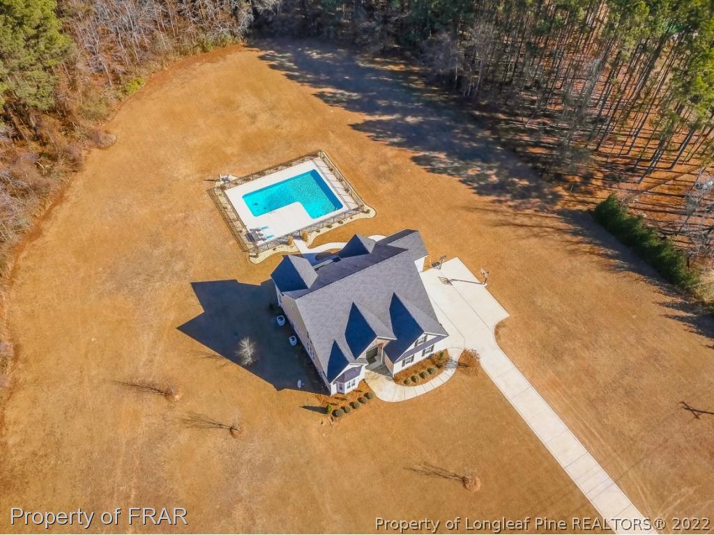 5491 Murphy Road Stedman, NC 28391 - Photo 30 of 33 an aerial view of a house with swimming pool and large trees