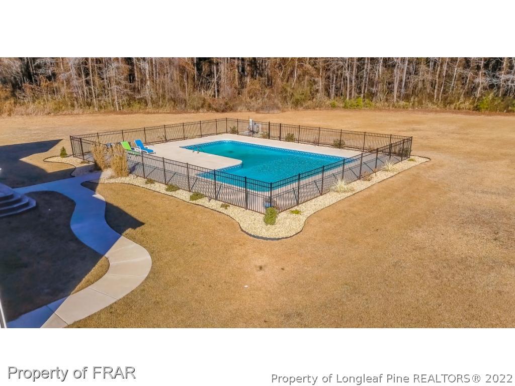 5491 Murphy Road Stedman, NC 28391 - Photo 33 of 33 a swimming pool with lawn chairs