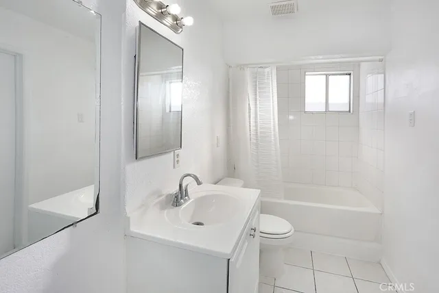 a white bath tub sitting next to a toilet