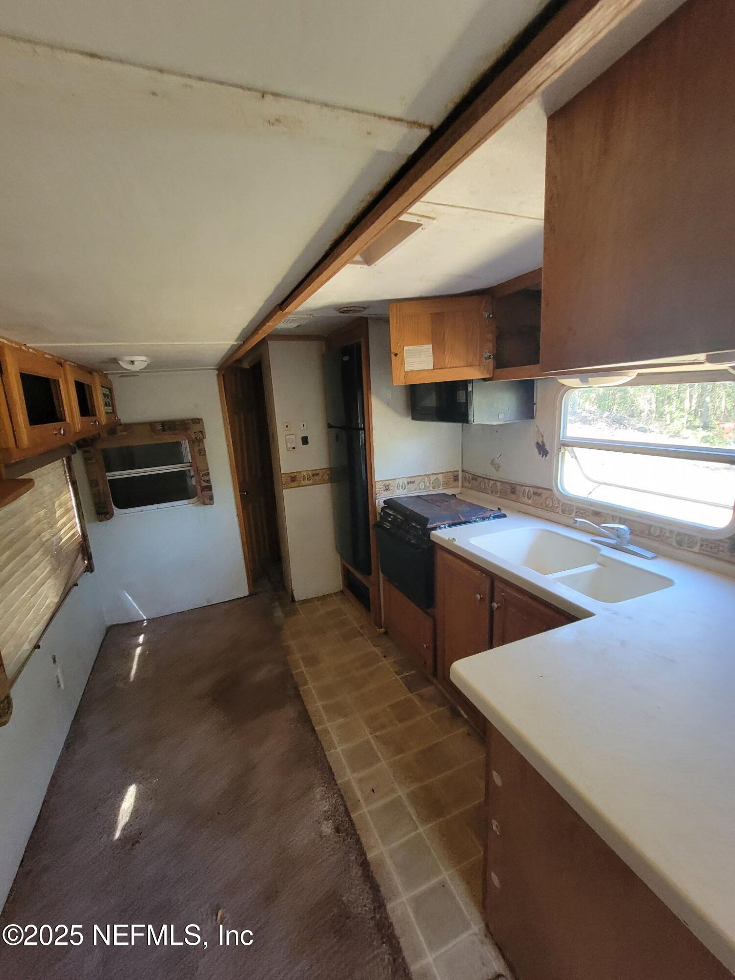 333 2nd Way Interlachen, FL 32148 - Photo 10 of 13 a kitchen with stainless steel appliances wooden cabinets and a stove top oven
