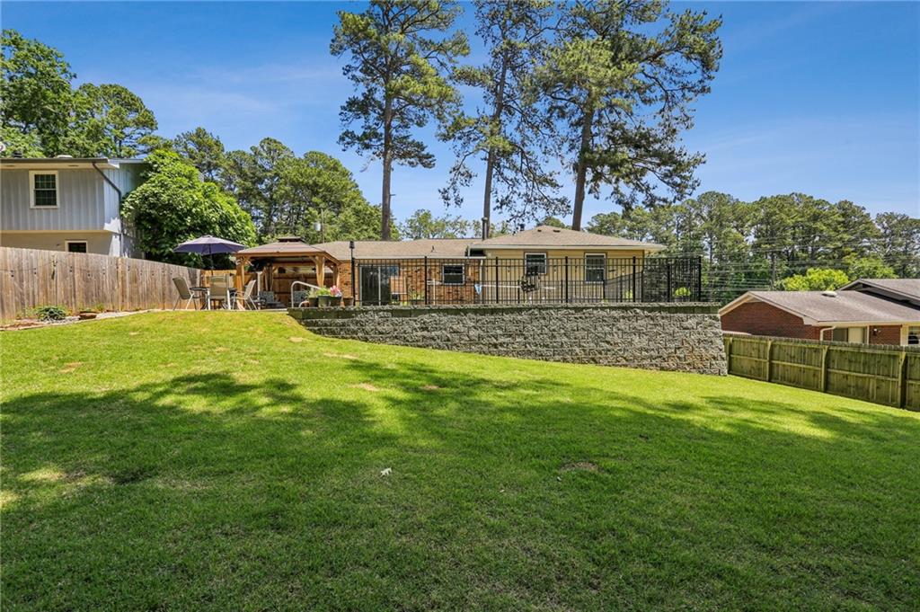 2740 Frontier Trail Atlanta, GA 30341 - Photo 7 of 29 a view of a house with a backyard and a patio