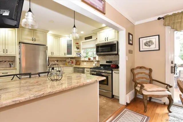 a kitchen with stainless steel appliances granite countertop a sink a stove and a refrigerator