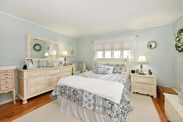 a room with a bed and a dresser in it