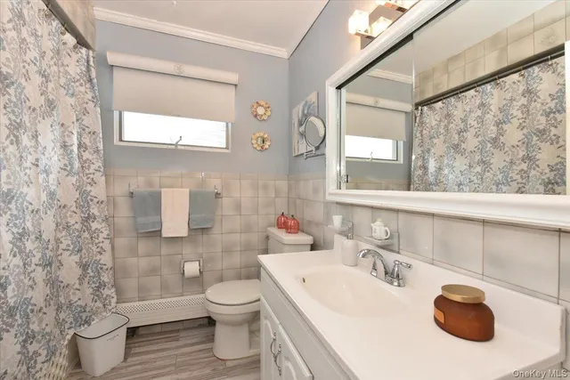 a bathroom with a sink toilet and mirror