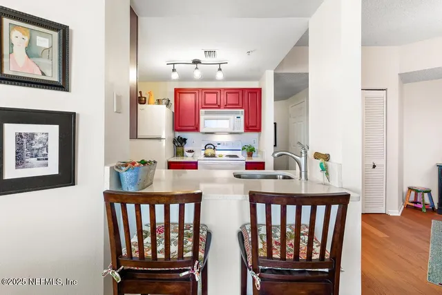 a kitchen with a sink a large window and a potted plant