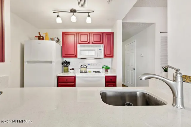 a view of a dining room with a table and chairs