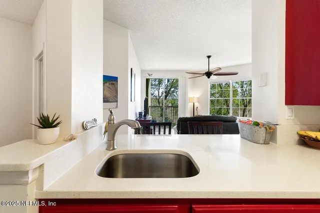 a view of walk in closet with clothes