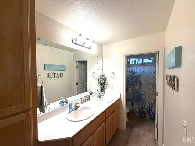 a bathroom with a sink vanity granite and a mirror