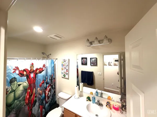 a bathroom with a sink mirror and vanity