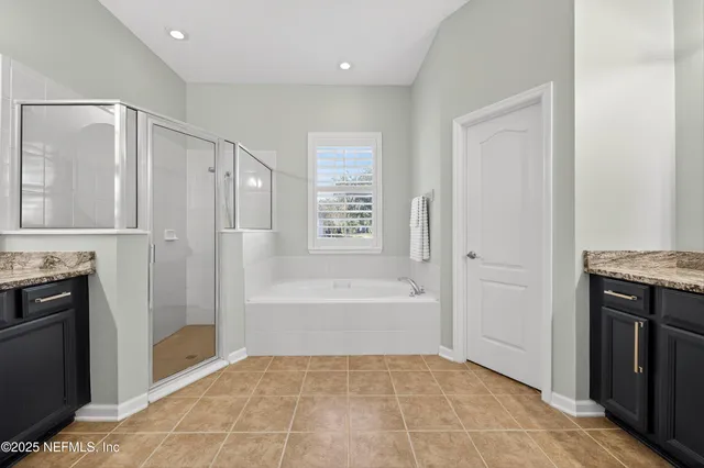 a bathroom with a sink a bathtub and a mirror