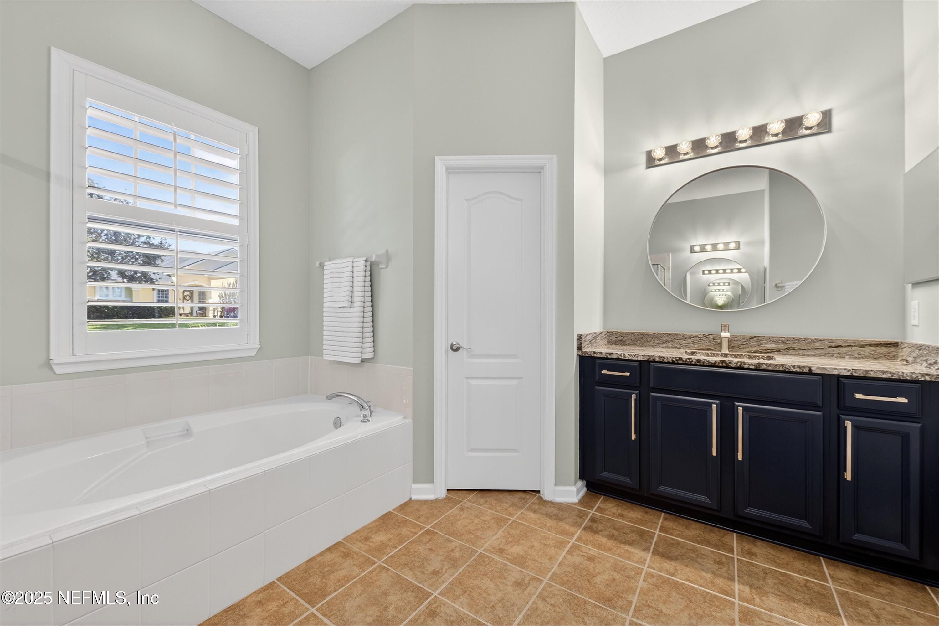 1104 Westfield Way St. Augustine, FL 32095 - Photo 15 of 53 a bathroom with a sink a bathtub and a mirror