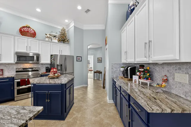 a kitchen with stainless steel appliances granite countertop a refrigerator a stove top oven a sink and dishwasher